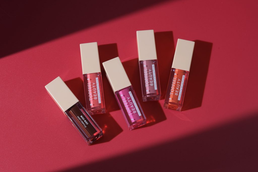 lip gloss tubes, colorful liquid inside , designed for adding shine and color to the lips.