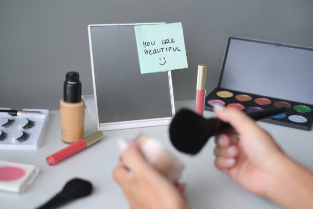 Close up shot of unrecognizable woman doing make up at home. She's using a Face Powder