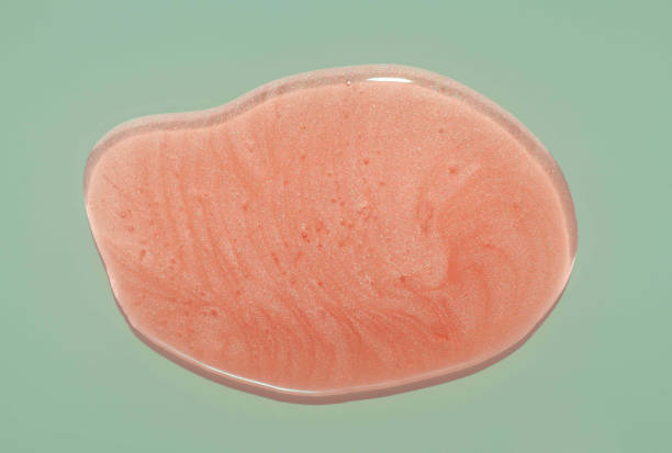 Lip gloss blur pink orange colour smudge sample isolated on light mint pistachio green background