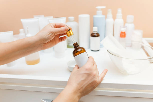 A woman holds a small vial with a medical product for a cosmetology clinic. pharmacy concept